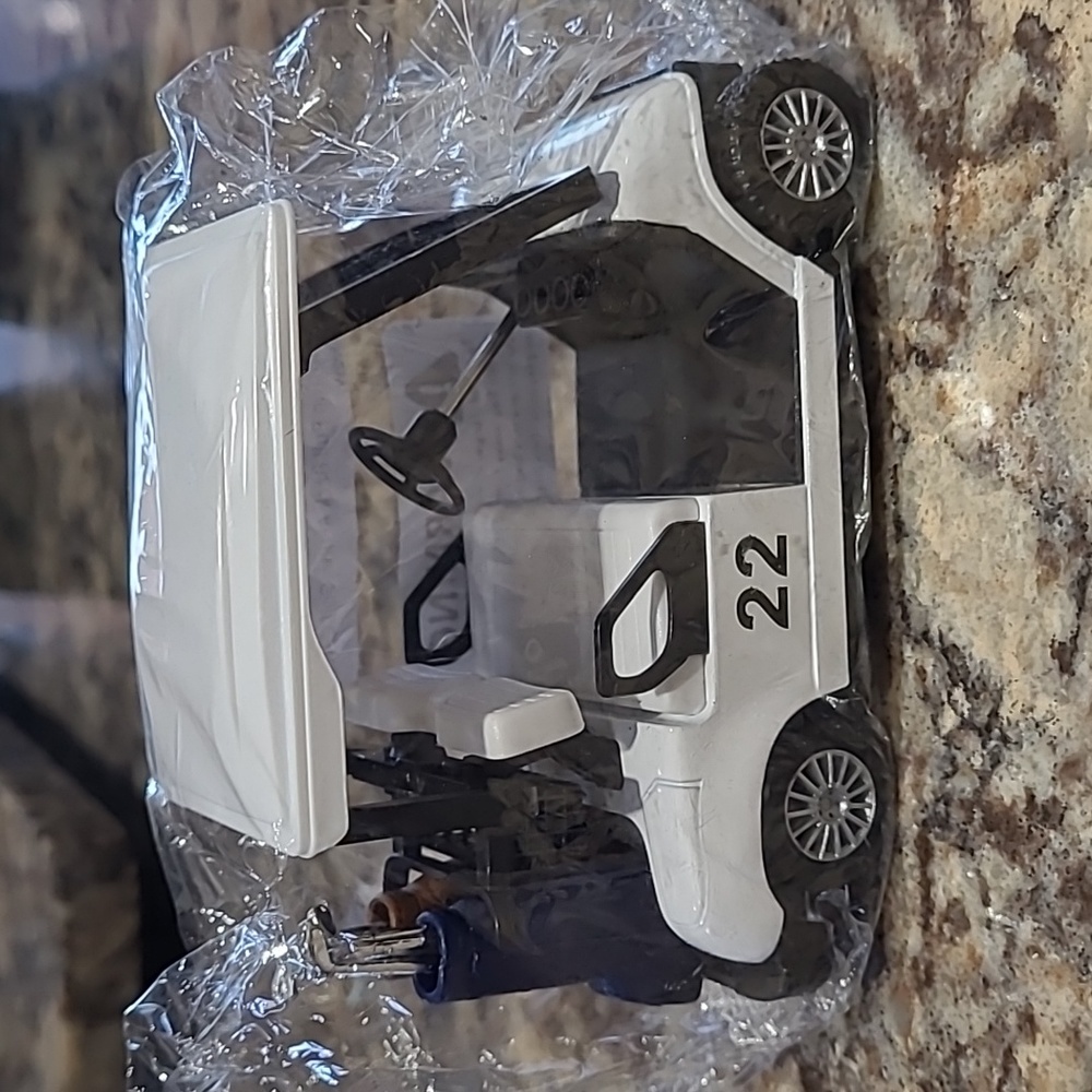 Miniature golf cart with individual golf clubs